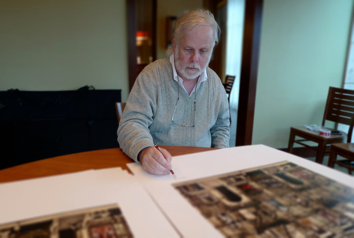 Photo of Peter Corriston signing the Led Zeppelin Physical Graffiti print at his home in New York State.